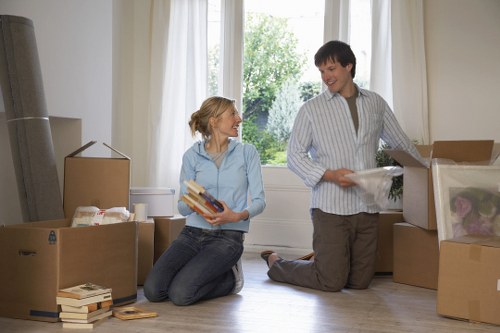 Professional mover carrying a boxed item carefully