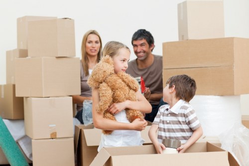 Professional movers carrying furniture through a Bermondsey property